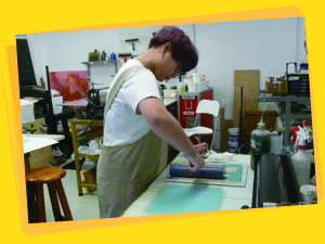 This student starts her print-making practice in the Printshop.