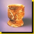 Pottery jug with perforated
  ring-foot and incised design