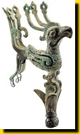 Bronze bird perched on bud of mythical tree