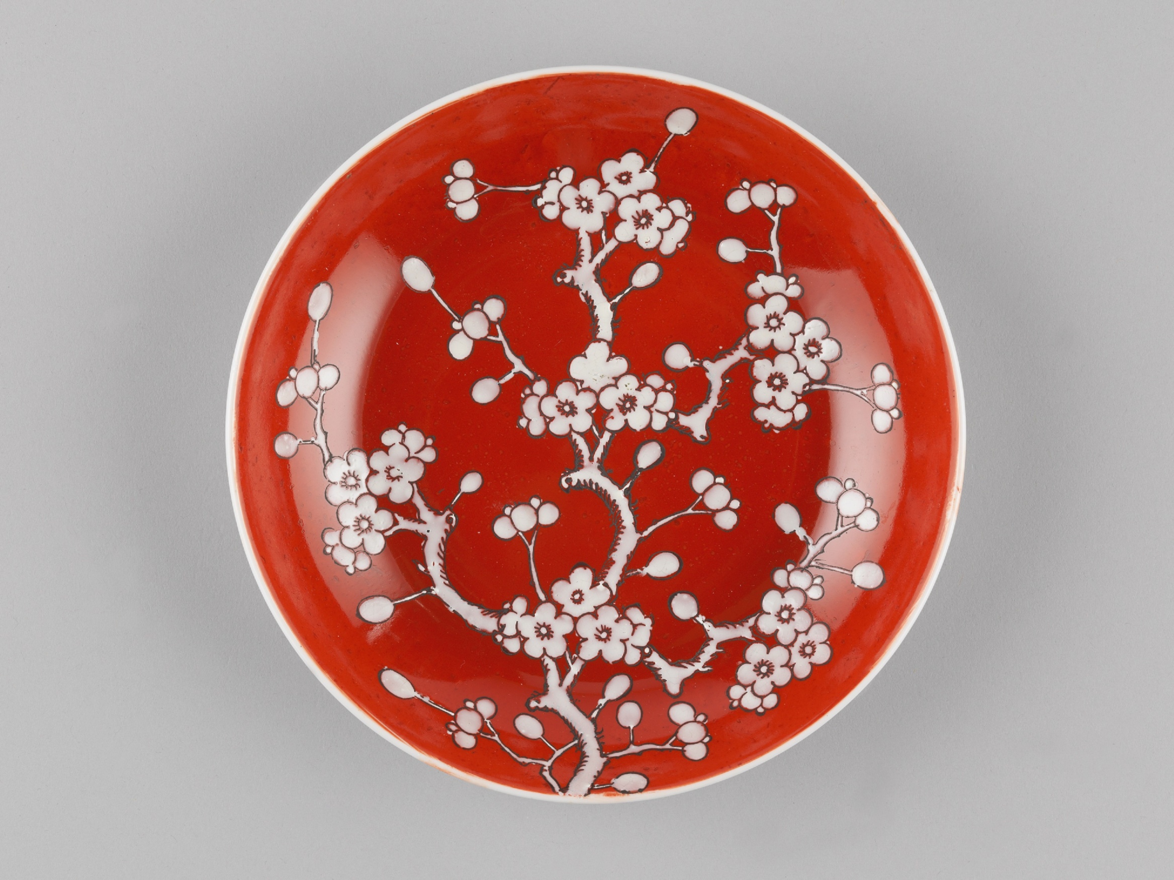 Plate with white prunus on red-ground